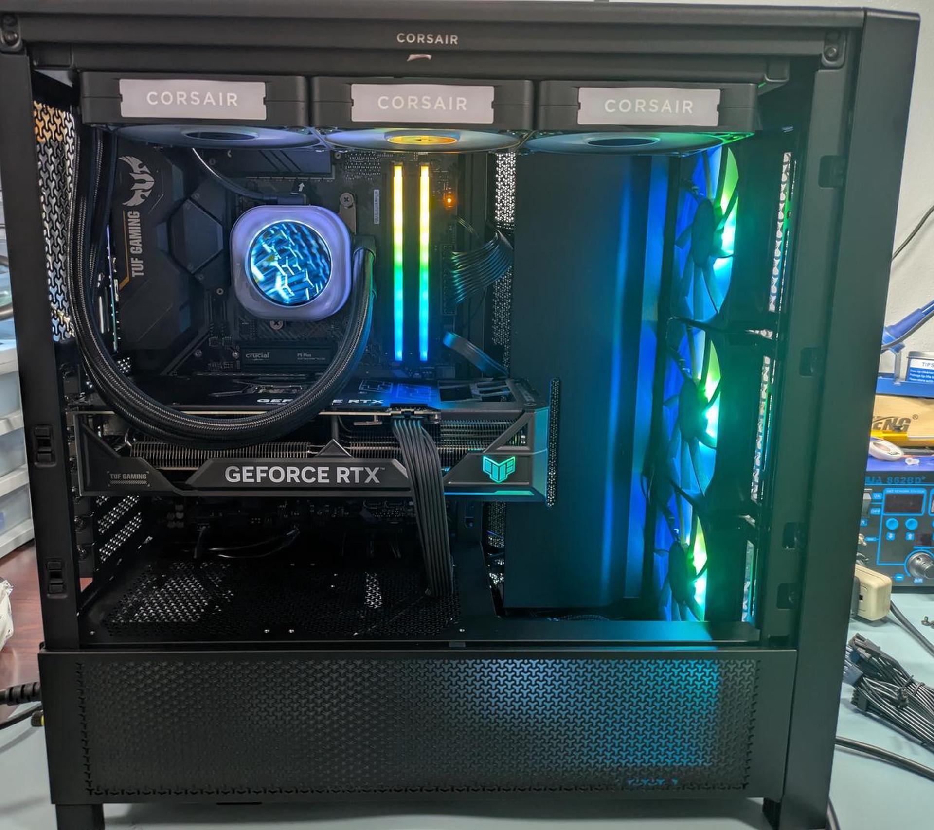 Open computer case with Corsair components and a GeForce RTX graphics card.