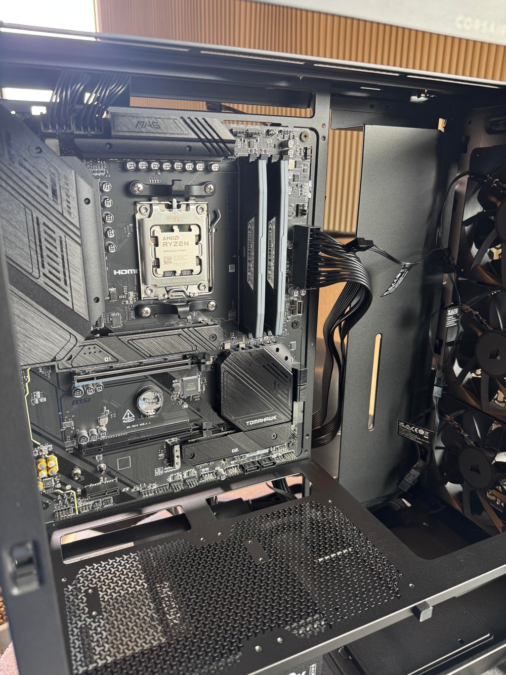 Computer motherboard inside an open computer case with visible components.