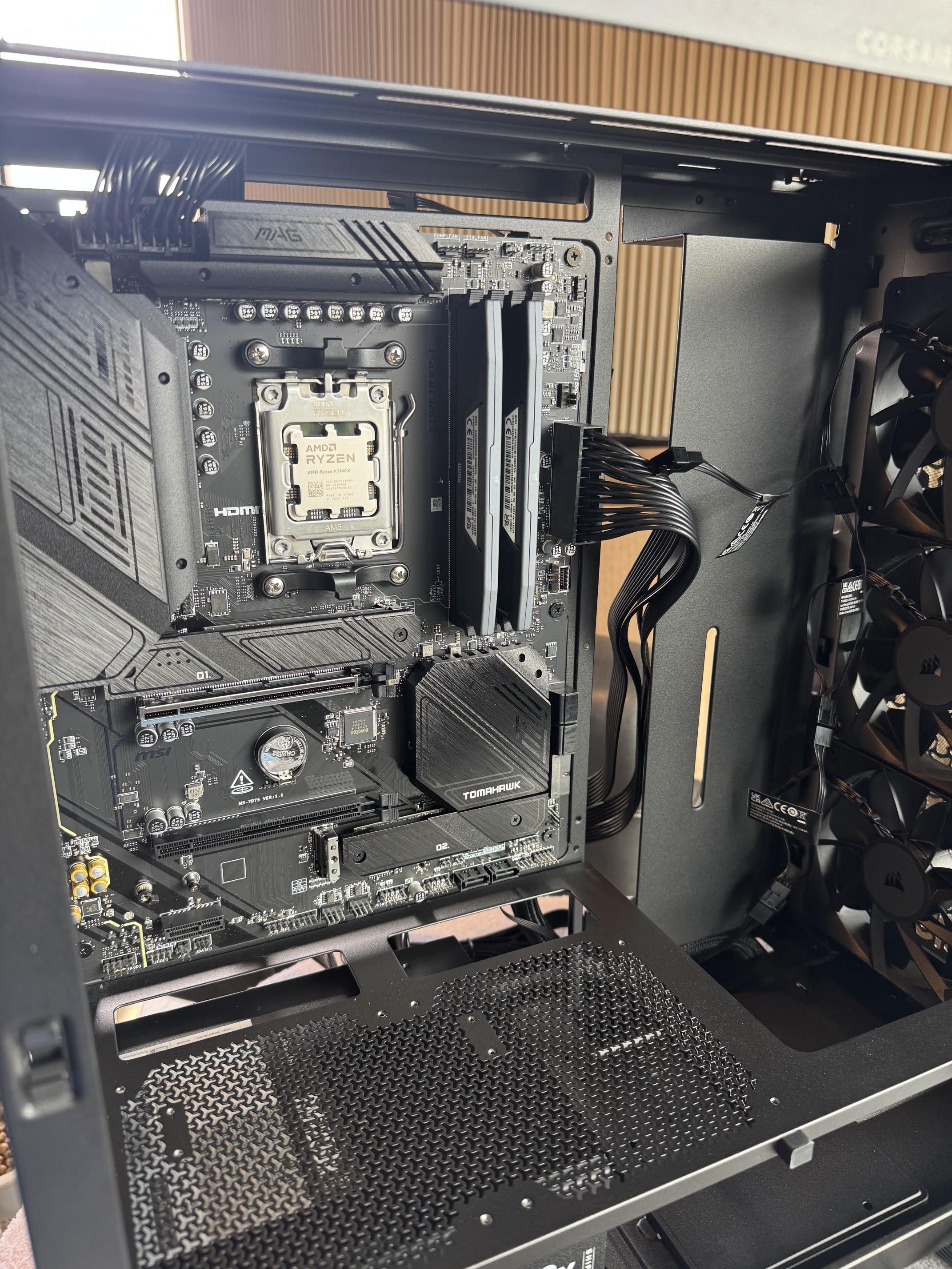 Computer motherboard inside an open computer case with visible components.